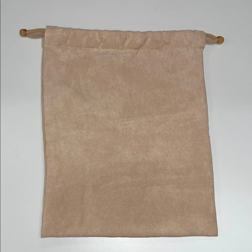 Elegant Tan Faux Suede Drawstring Bag for storage.